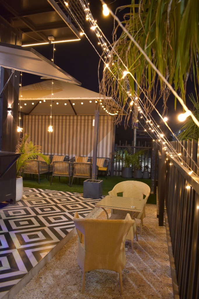 One18 fairy-lit pathway with wicker seating