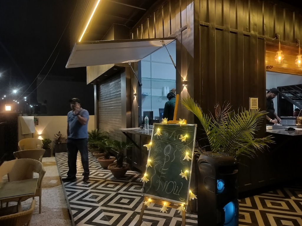 One18 Cafe rooftop lounge with string lights and canopy